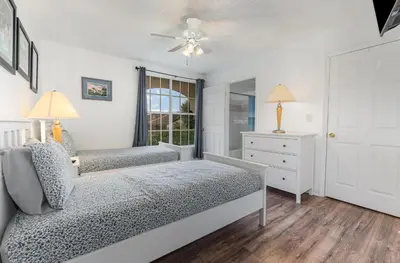 a bedroom with two beds and a window at 8702 PAPAYA DR 2BED in Kissimmee