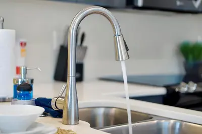 a kitchen sink with water running from a faucet at 1617 Retreat Circle Clermont 3 BED in Orlando