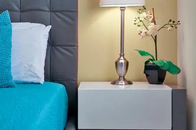 a lamp on a night stand next to a bed at 1617 Retreat Circle Clermont 3 BED in Orlando