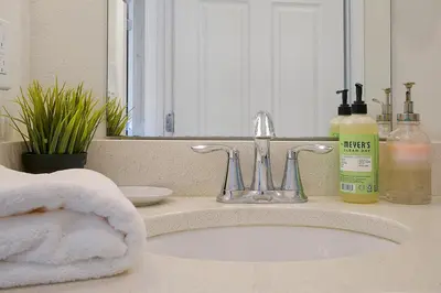 a bathroom counter with a sink and a mirror at 1617 Retreat Circle Clermont 3 BED in Orlando