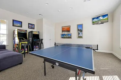 a living room with a ping pong table and video games at 1617 Retreat Circle Clermont 3 BED in Orlando