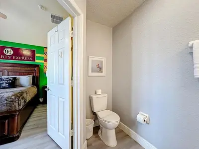 a bathroom with a toilet and a bed in a room at T2531M Windsor Hills Resort 3Bedrm Private Pool in Orlando