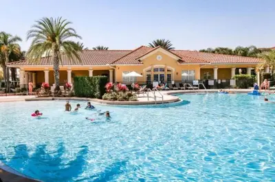 a group of people swimming in a large swimming pool at 2888 OAKWATER KISSIMMEE 3BEDS in Orlando