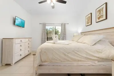 a bedroom with a bed and a dresser with a swan on it at OAKWATER KISSIMMEE 3 BEDS in Orlando