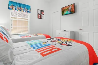 a bedroom with two beds with mickey mouse on it at OAKWATER KISSIMMEE 3 BEDS in Orlando