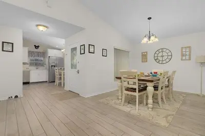 a kitchen and dining room with a table and chairs at 7742 WATER OAK KISSIMMIEE 4BED in Orlando