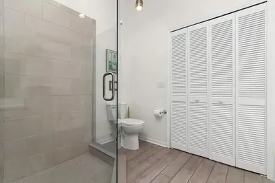 a bathroom with a toilet and a glass shower at 7742 WATER OAK KISSIMMIEE 4BED in Orlando