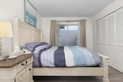a bedroom with a bed and a desk and a window at 7742 WATER OAK KISSIMMIEE 4BED in Orlando