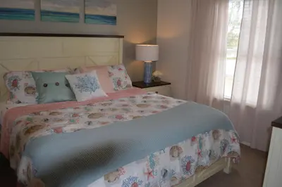 a bedroom with a bed and a window at Charming 4-Bedroom Townhome in Lucaya Village Near Disney in Kissimmee