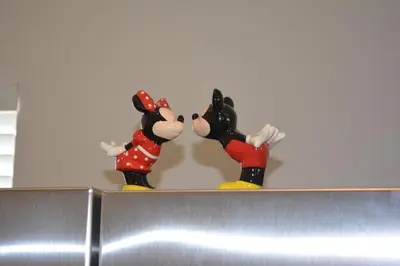 three mickey mouse figurines on top of a refrigerator at Charming 4-Bedroom Townhome in Lucaya Village Near Disney in Kissimmee