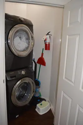 a washing machine in a room next to a door at Charming 4-Bedroom Townhome in Lucaya Village Near Disney in Kissimmee