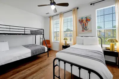 a bedroom with two beds and a ceiling fan at Beautiful Epic Universe Townhome, Vista Cay-4034 in Orlando