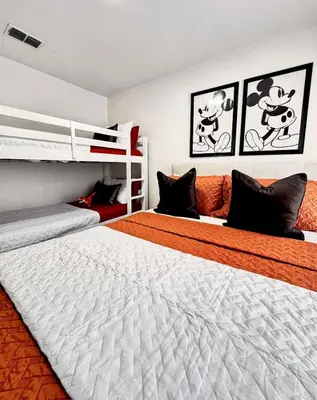 two beds in a bedroom with two bunk beds at Modern 3BR Retreat with Comfort & Style Near Disney in Kissimmee