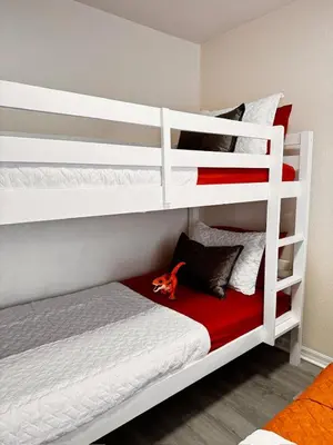 a bedroom with two bunk beds with a red blanket at Modern 3BR Retreat with Comfort & Style Near Disney in Kissimmee