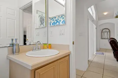 a bathroom with a sink and a mirror at 108 Stetson Court Kissimie in Kissimmee
