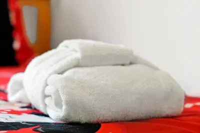 a pile of white towels sitting on a bed at 108 Stetson Court Kissimie in Kissimmee