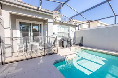 a house with a swimming pool in the backyard at TVPM-5005WASL in Kissimmee