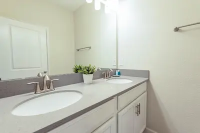 a bathroom with two sinks and a large mirror at TVPM-5005WASL in Kissimmee