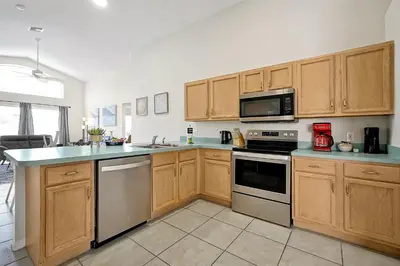a kitchen with wooden cabinets and a stove top oven at 938 Lake Berkley Kissimmee FL 34746 in Kissimmee