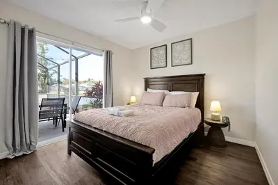 a bedroom with a large bed and a balcony at 938 Lake Berkley Kissimmee FL 34746 in Kissimmee