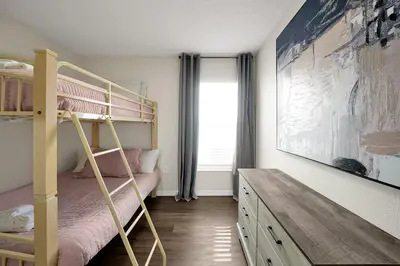 a bedroom with a bunk bed and a desk at 938 Lake Berkley Kissimmee FL 34746 in Kissimmee