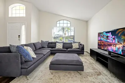 a living room with a couch and a flat screen tv at 938 Lake Berkley Kissimmee FL 34746 in Kissimmee