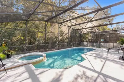 a swimming pool with a pergola next to a swimming pool at TVPM-1191MBBV in Kissimmee
