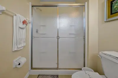 a shower with a glass door in a bathroom at 4703 Flagler Beach Way Kissimmee Florida 3BED in Kissimmee