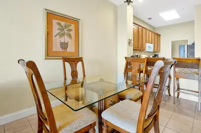 a dining room with a glass table and chairs at 13415 BLUE HERRON BEACH DR in Orlando