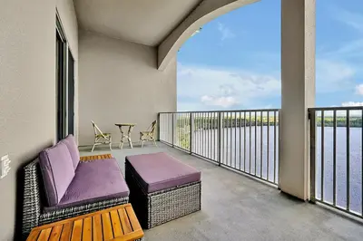 a balcony with a purple couch and a table at 13415 BLUE HERRON BEACH DR in Orlando