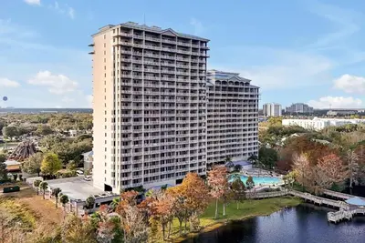 a tall white building next to a river at 13427 BLUE HERRON TOWER 1 UNIT 707 ORLANDO 1 BED in Orlando