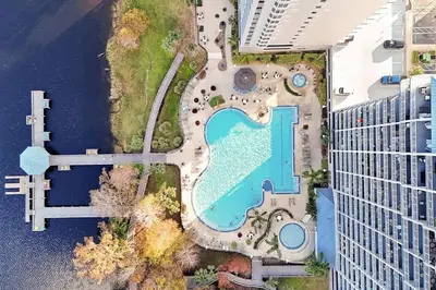 an overhead view of a swimming pool next to a building at 13427 BLUE HERRON TOWER 1 UNIT 707 ORLANDO 1 BED in Orlando