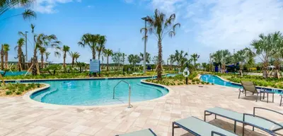 a swimming pool at a resort with palm trees at 3161 PARADOX CIRCLE UNIT 406 KISSIMMEE 2 BEDS in Kissimmee