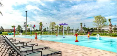 a swimming pool with chairs and a water park at 3161 PARADOX CIRCLE UNIT 406 KISSIMMEE 2 BEDS in Kissimmee