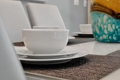 a white cup and saucers on a counter at 5017 WINDERMERE 4BED in Kissimmee