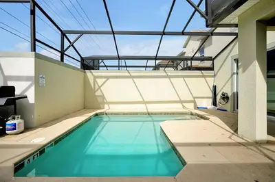 an indoor swimming pool with a glass ceiling at 5017 WINDERMERE 4BED in Kissimmee