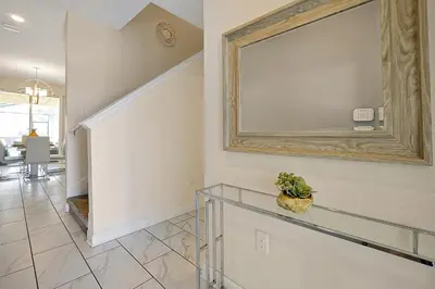 a hallway with a mirror on the wall at 5017 WINDERMERE 4BED in Kissimmee