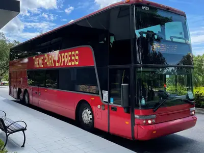 a red double decker bus parked next to a bench at Wyndham Garden Lake Buena Vista – Disney Springs® Area in Orlando