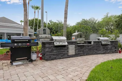 a barbecue grill in a brick wall in a yard at Prime Location 1BR Apt Near Epic OCCC in Orlando