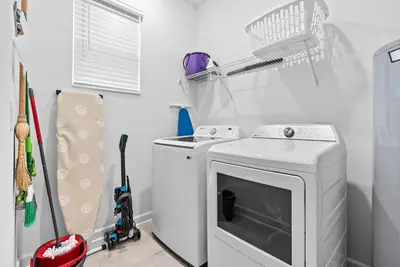 a white washer and dryer in a laundry room at Home 07 Bedrooms6 Baths At Storey Lake in Kissimmee
