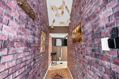 a brick wall in a hallway with art on it at Home 07 Bedrooms6 Baths At Storey Lake in Kissimmee