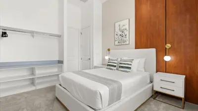 a white bedroom with a white bed and a window at Lakeside Villa with Pool BBQ Cinema & Games Room in Kissimmee