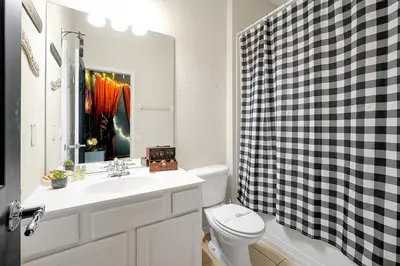 a bathroom with a sink and a toilet and a mirror at 7823 BEACHFIELD KISSIMME 4BED in Orlando