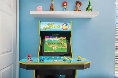 a video game room with a pinball machine at Emerald- 2793 in Kissimmee