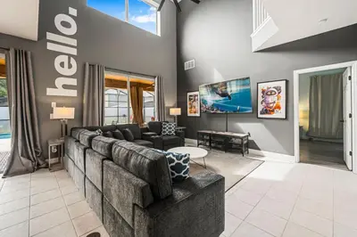 a living room with a couch and a tv at Emerald- 2793 in Kissimmee