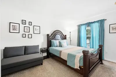 a bedroom with a bed and a couch at Pond View Club Cortile Resort Pool Hot Tub Theme in Kissimmee