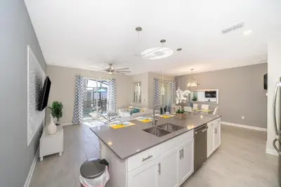 a kitchen with a sink and a counter top at Stunning Retreat Townhouse 4 Beds and 10 Mins to Disney With Pool in Kissimmee