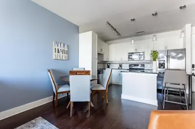 a kitchen and dining room with a table and chairs at Landing Stylish 1BD Rooftop Lounge Gym in Orlando