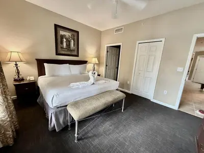 a bedroom with a large bed with a white comforter at Entire Condo - 3Bed 2Bath- 5 mins to Disney Park in Orlando