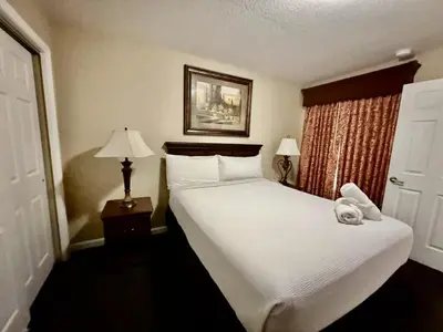 a bedroom with a large white bed and two lamps at Entire Condo - 3Bed 2Bath- 5 mins to Disney Park in Orlando
